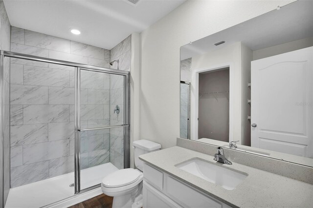 bathroom with vanity, toilet, an enclosed shower, and hardwood / wood-style flooring