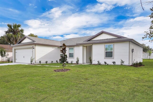 single story home with a garage and a front lawn