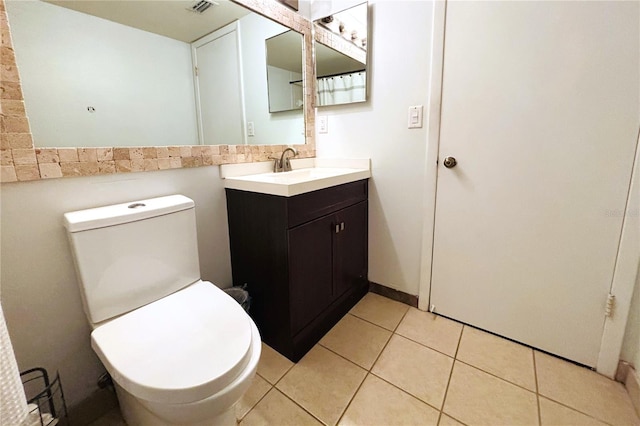 bathroom featuring tile patterned flooring, vanity, and toilet