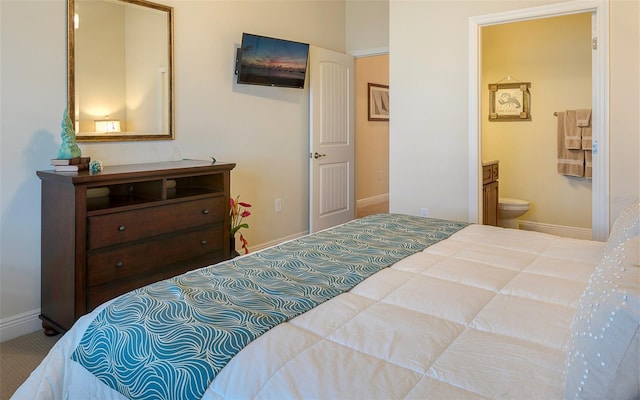 carpeted bedroom featuring ensuite bathroom