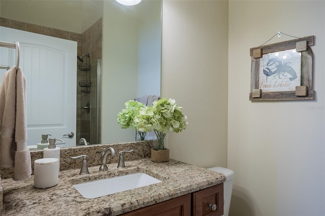 bathroom featuring a tile shower and vanity