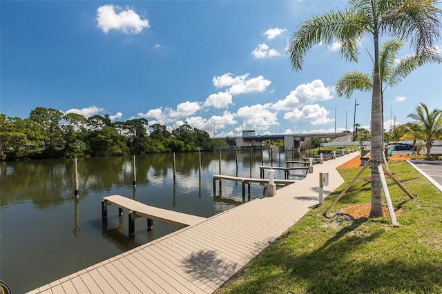 dock area featuring a water view and a lawn