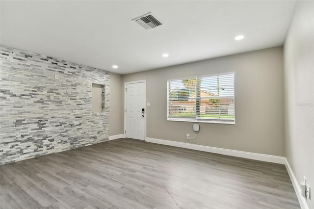 empty room with hardwood / wood-style floors