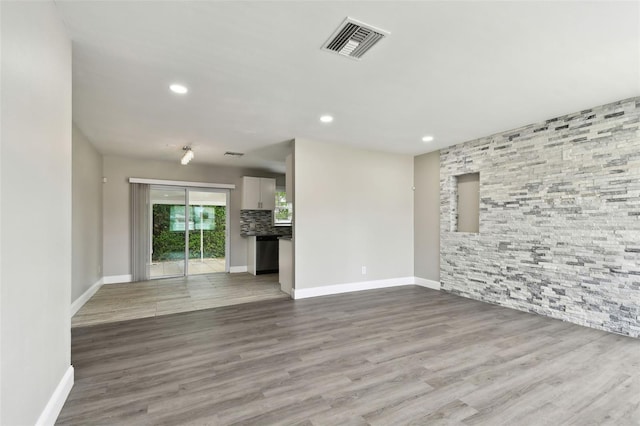 unfurnished living room with wood-type flooring