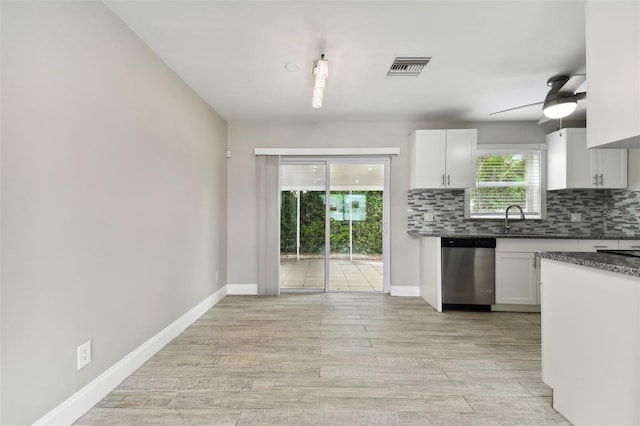 kitchen with dishwasher, ceiling fan, white cabinets, and light hardwood / wood-style floors