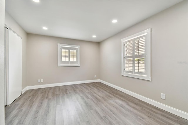 empty room featuring a wealth of natural light and light hardwood / wood-style floors