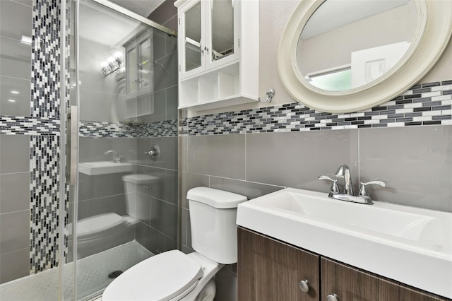 bathroom with vanity, an enclosed shower, tile walls, toilet, and decorative backsplash