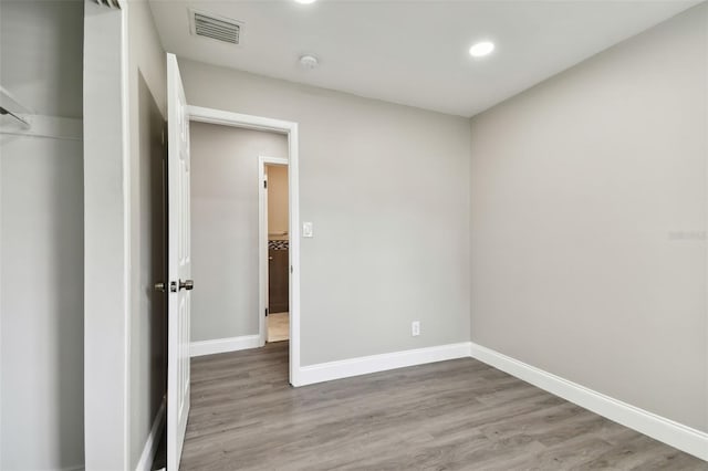 unfurnished bedroom with hardwood / wood-style flooring