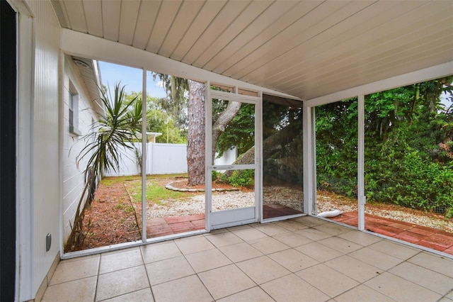 unfurnished sunroom featuring wooden ceiling and a healthy amount of sunlight