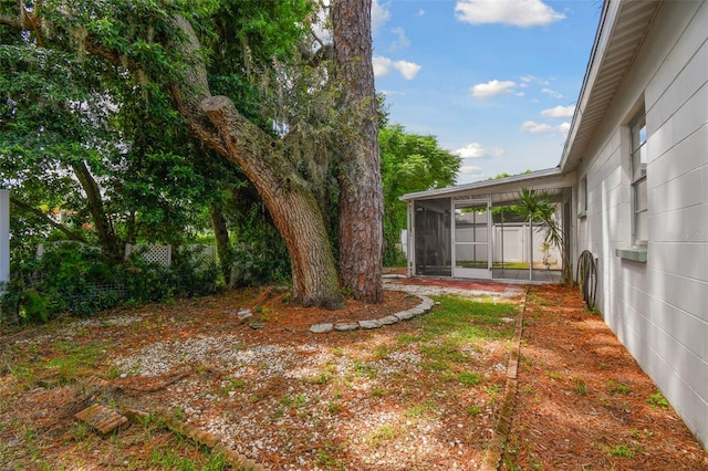 view of yard featuring a sunroom