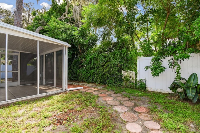 view of yard featuring a patio area and a sunroom