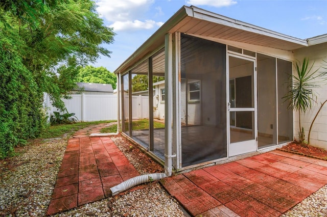 exterior space with a patio area and a sunroom