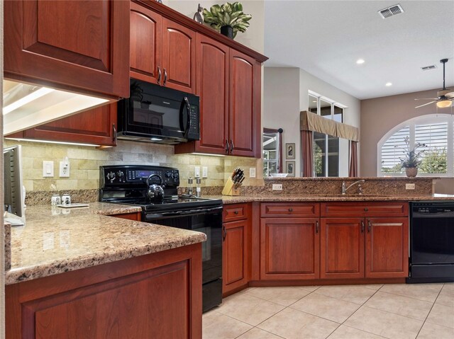 kitchen featuring light stone countertops, visible vents, a sink, black appliances, and tasteful backsplash