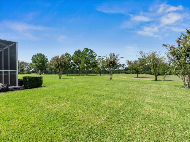 view of yard featuring glass enclosure