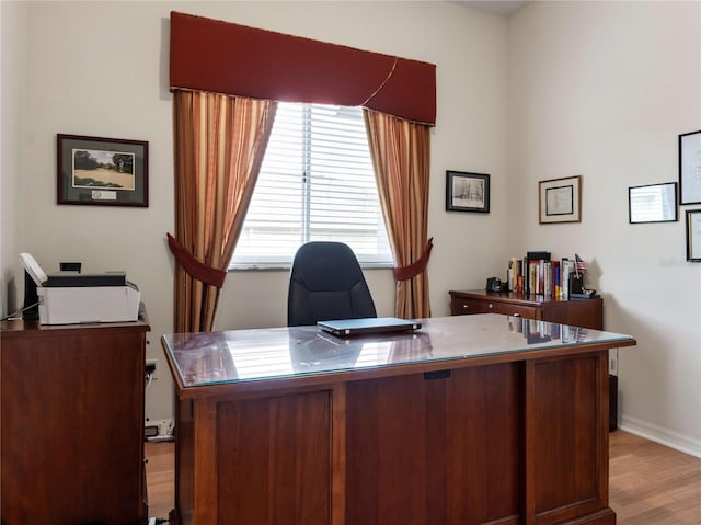 office space with light wood-style floors and baseboards