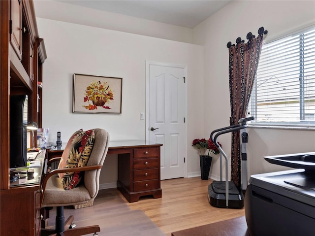 home office featuring light wood-style flooring and baseboards