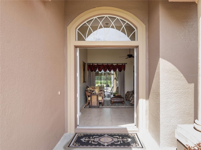 view of exterior entry with stucco siding