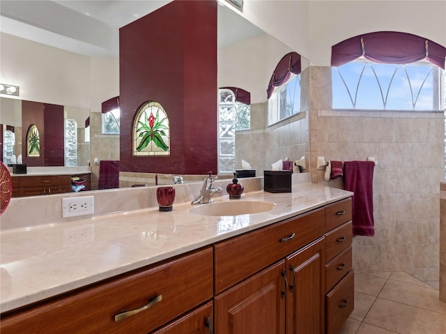 bathroom featuring tile patterned floors, tile walls, and vanity