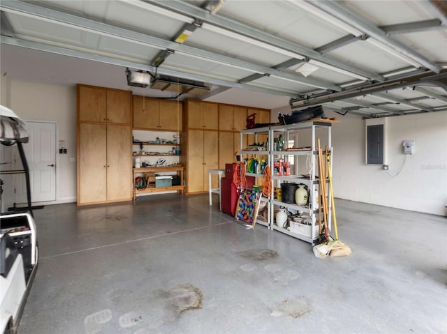 garage with electric panel and a garage door opener