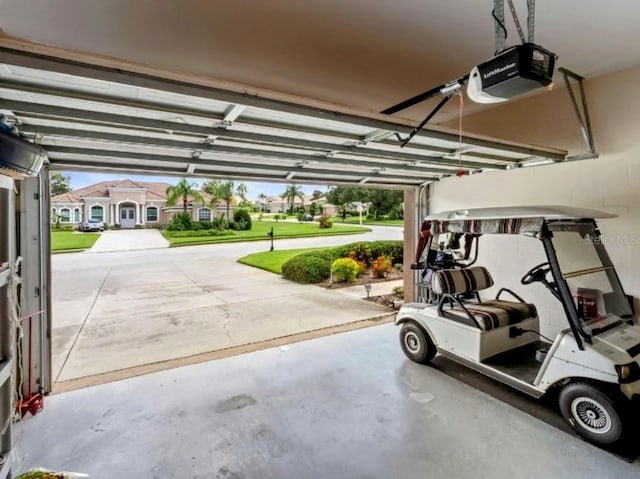 garage with a garage door opener and a residential view