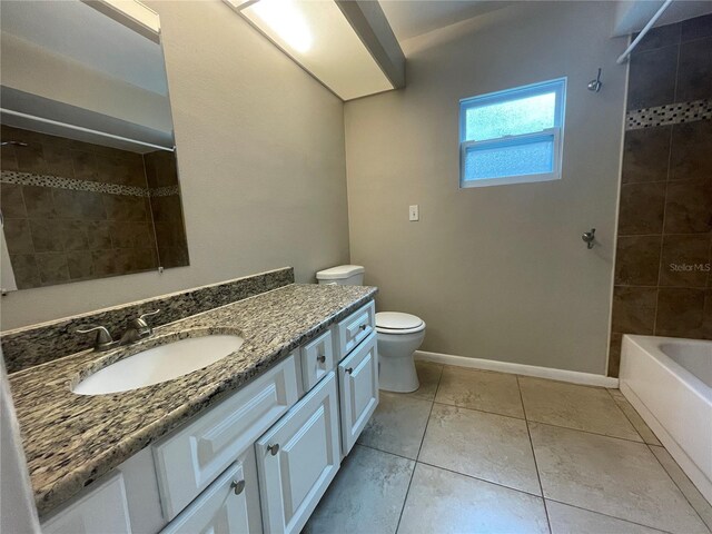 full bathroom with tile patterned flooring, tiled shower / bath, vanity, and toilet