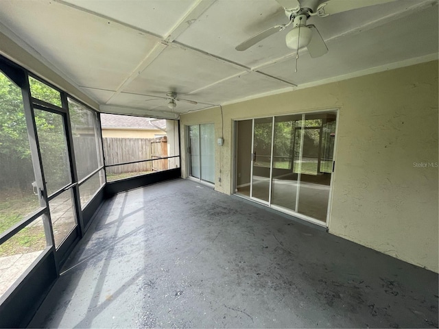 unfurnished sunroom with ceiling fan