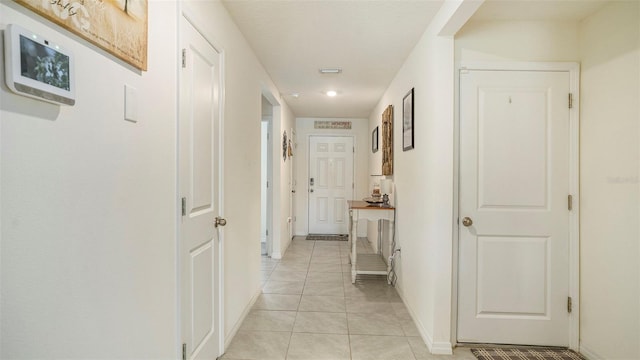 hallway featuring light tile patterned floors