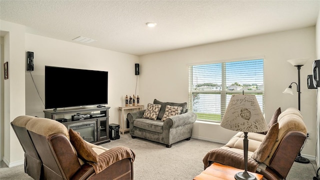 carpeted living room featuring a textured ceiling