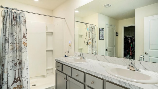 7774 Sail Clover Ln, Zephyrhills, FL 33540 - bathroom featuring visible vents, a sink, a spacious closet, and curtained shower