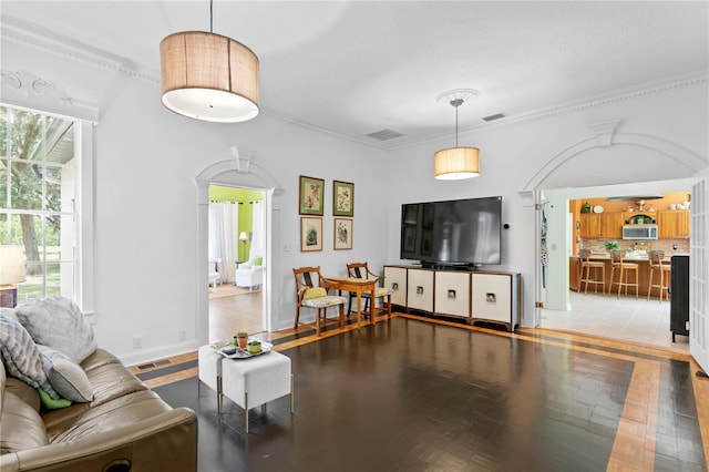 living room with ceiling fan, hardwood / wood-style flooring, and crown molding