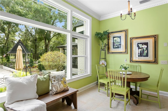 sunroom / solarium with a chandelier