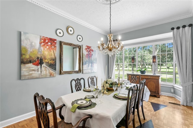 dining area featuring a notable chandelier, a textured ceiling, ornamental molding, and light parquet flooring