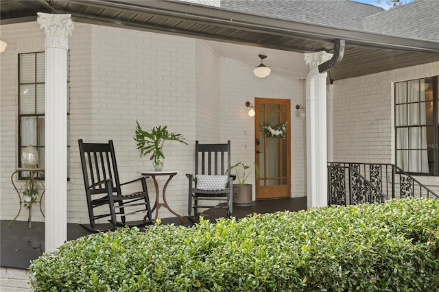 view of exterior entry featuring covered porch