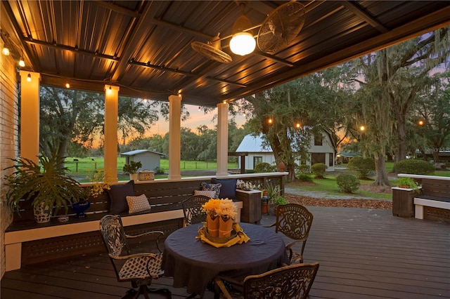 deck at dusk with ceiling fan