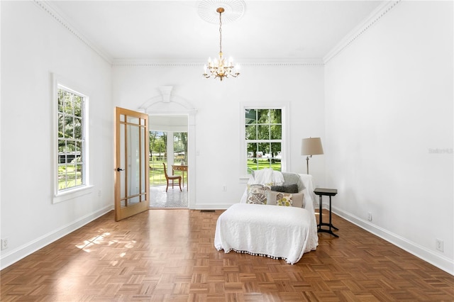 sitting room featuring parquet floors, ornamental molding, an inviting chandelier, and plenty of natural light