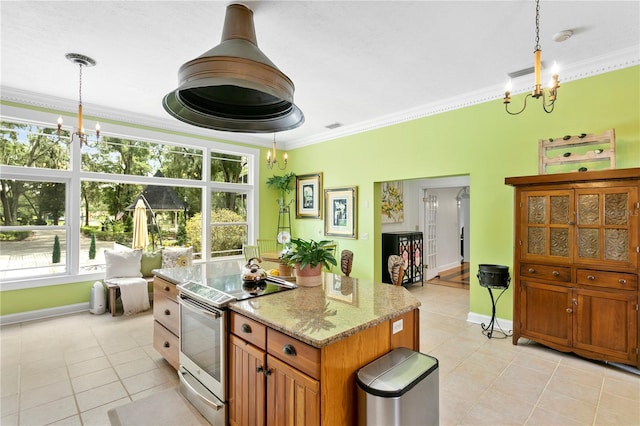 kitchen featuring crown molding, plenty of natural light, electric stove, and decorative light fixtures