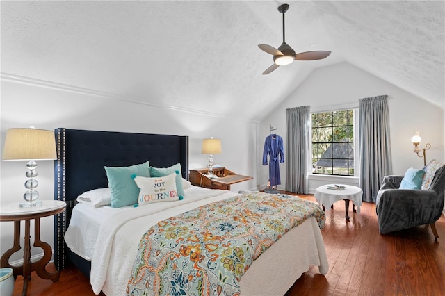 bedroom with a textured ceiling, vaulted ceiling, ceiling fan, and hardwood / wood-style flooring