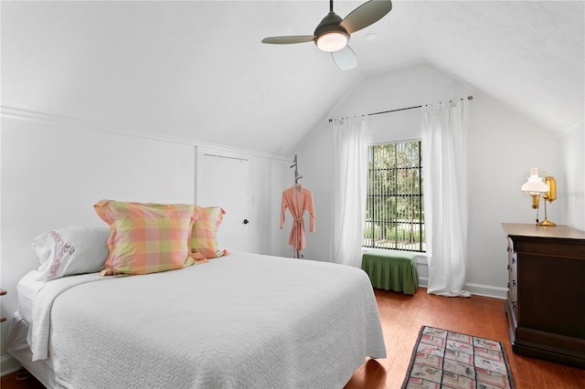 bedroom with light wood-type flooring, vaulted ceiling, and ceiling fan