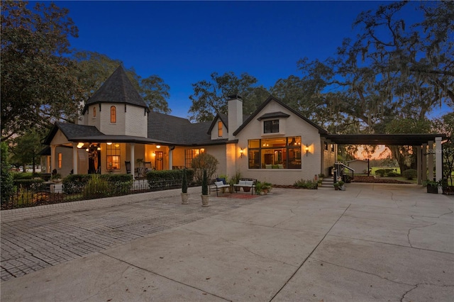 view of front of property featuring a porch and a carport