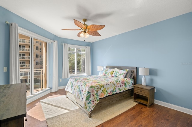 bedroom with ceiling fan and dark hardwood / wood-style floors