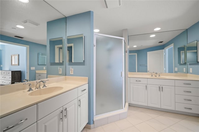 bathroom with vanity, tile patterned floors, and a shower with door