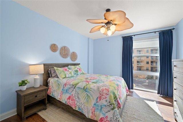 bedroom with ceiling fan and wood-type flooring