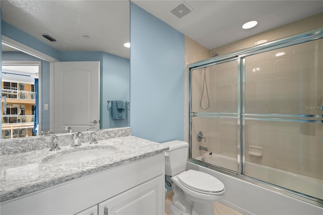 full bathroom with vanity, toilet, and enclosed tub / shower combo