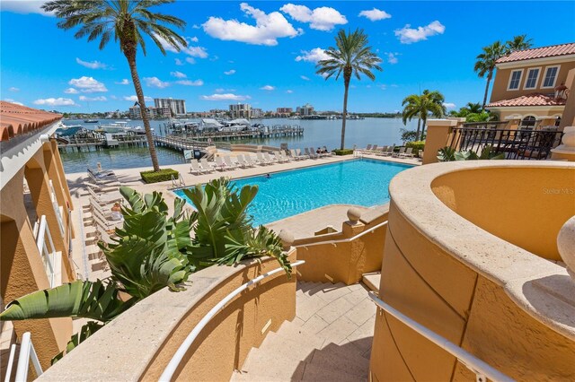 view of swimming pool featuring a water view