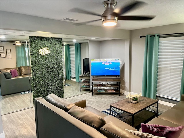 1478 Alternate Keene Rd, Largo, FL 33771 - living area featuring light wood-style flooring, baseboards, ceiling fan, and visible vents