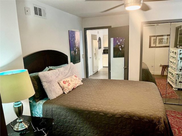 bedroom with a closet, ceiling fan, and wood-type flooring