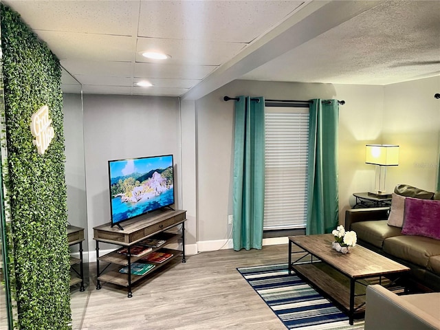 1478 Alternate Keene Rd, Largo, FL 33771 - living room featuring a paneled ceiling, baseboards, and wood finished floors