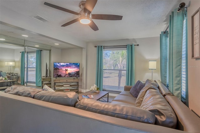 1478 Alternate Keene Rd, Largo, FL 33771 - living area with a wealth of natural light, visible vents, ceiling fan, and a textured ceiling