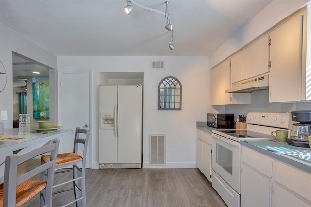 kitchen with light wood-type flooring and white appliances