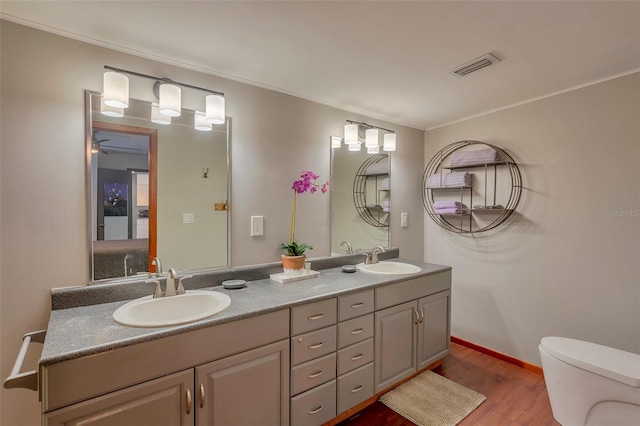 1478 Alternate Keene Rd, Largo, FL 33771 - bathroom featuring toilet, a sink, wood finished floors, and visible vents